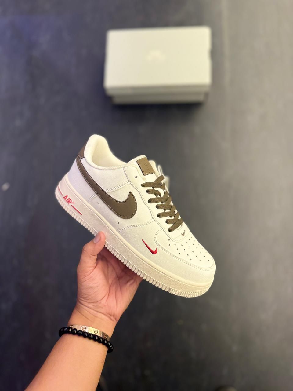 Nike Air Force 1 Low – Cream with Brown Swoosh & Red Mini Logo