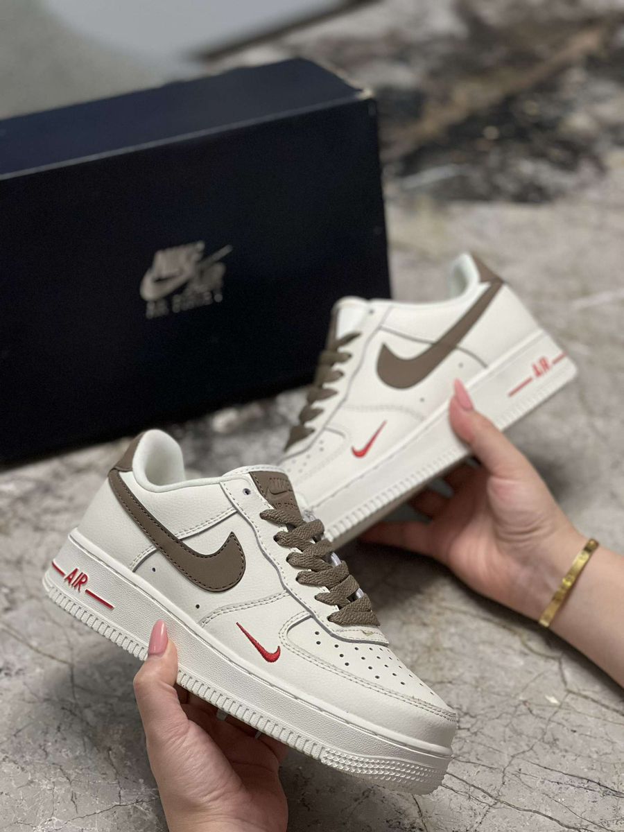Nike Air Force 1 Low – Cream with Brown Swoosh & Red Mini Logo